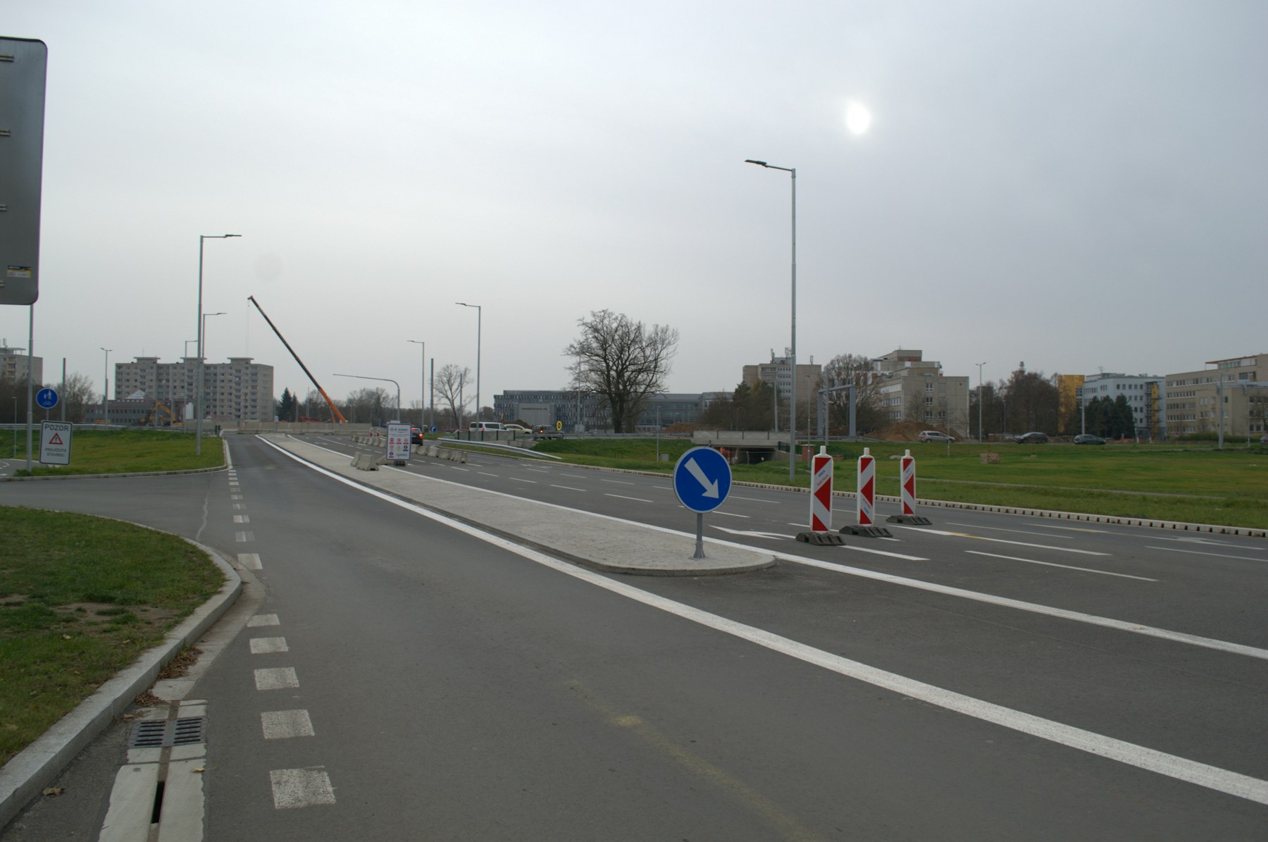 A newly built roadway with construction equipment still visible nearby